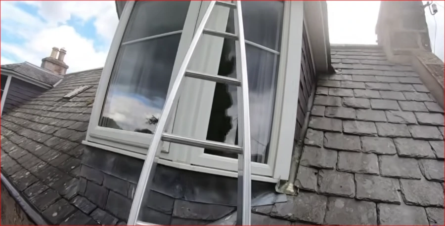 Window cleaning technician working on a home's exterior windows