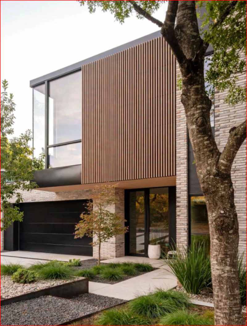 Modern home with large exterior windows and wood siding